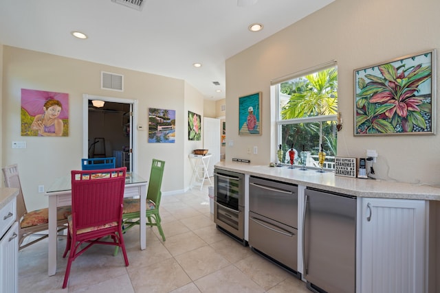 kitchen featuring light tile patterned floors, beverage cooler, and refrigerator