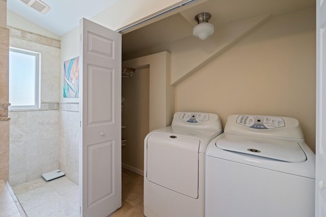 clothes washing area with separate washer and dryer