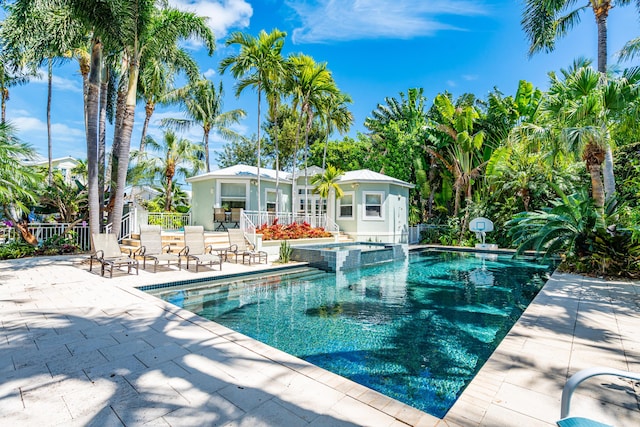 view of pool featuring an in ground hot tub and a patio