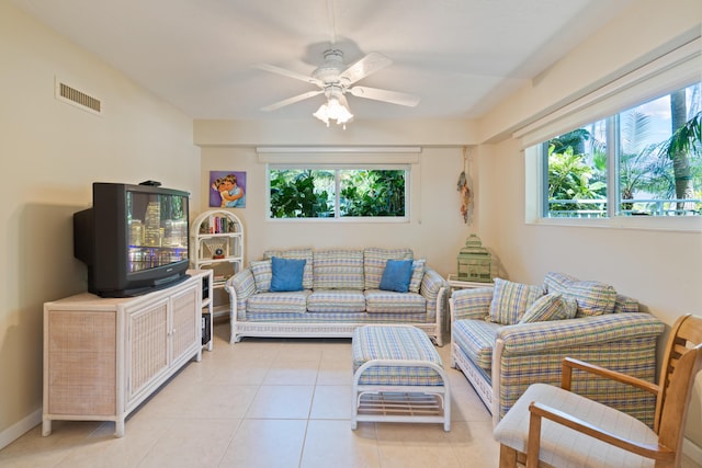 tiled living room with ceiling fan