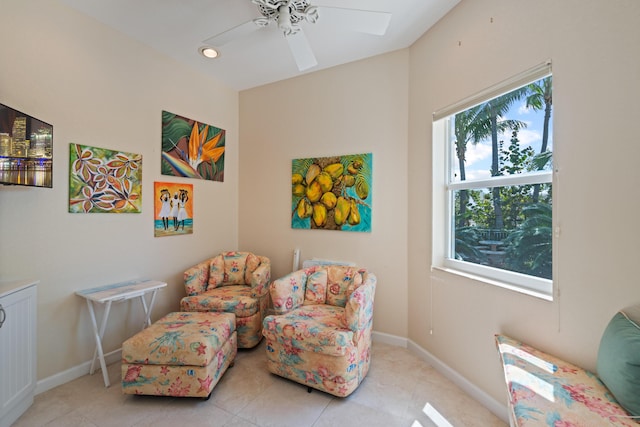 sitting room with light tile patterned floors and ceiling fan