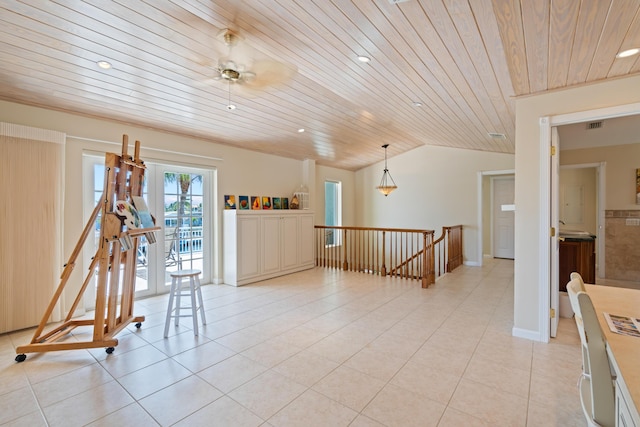 tiled spare room featuring wood ceiling and vaulted ceiling