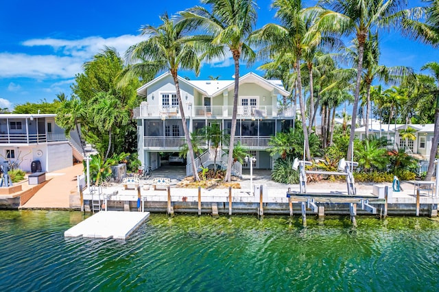 view of dock with a water view and a balcony