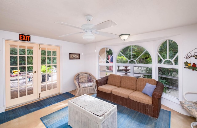 living area featuring french doors, healthy amount of natural light, and ceiling fan