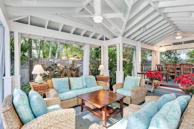 sunroom / solarium featuring ceiling fan and vaulted ceiling with beams