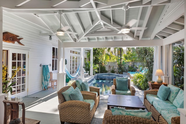 sunroom / solarium featuring vaulted ceiling with beams and ceiling fan