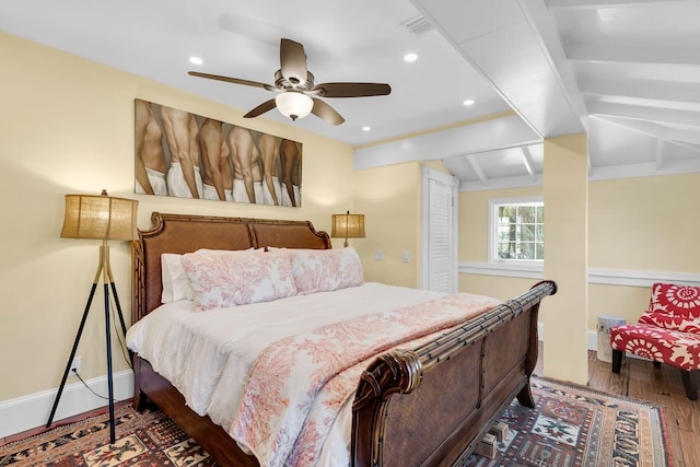 bedroom featuring ceiling fan, lofted ceiling, and dark hardwood / wood-style floors