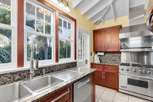 kitchen featuring sink, appliances with stainless steel finishes, tasteful backsplash, light stone counters, and wall chimney exhaust hood