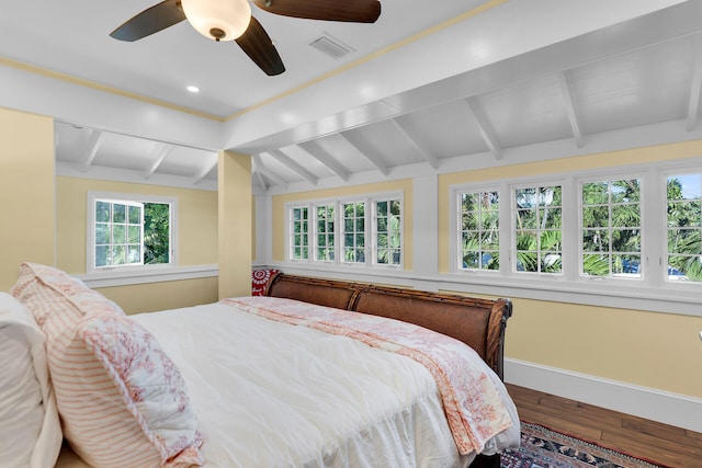 bedroom with lofted ceiling with beams, hardwood / wood-style flooring, and ceiling fan