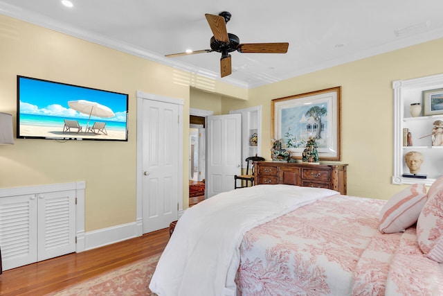 bedroom with crown molding, ceiling fan, and light hardwood / wood-style flooring