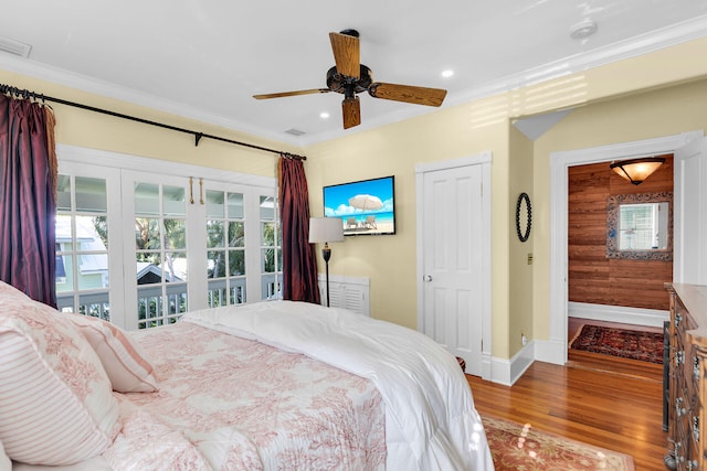 bedroom featuring multiple windows, crown molding, hardwood / wood-style floors, and ceiling fan