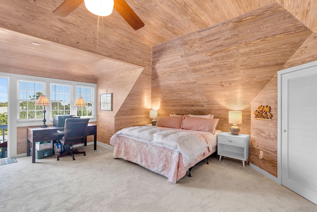 bedroom featuring wood ceiling, vaulted ceiling, wooden walls, carpet floors, and ceiling fan