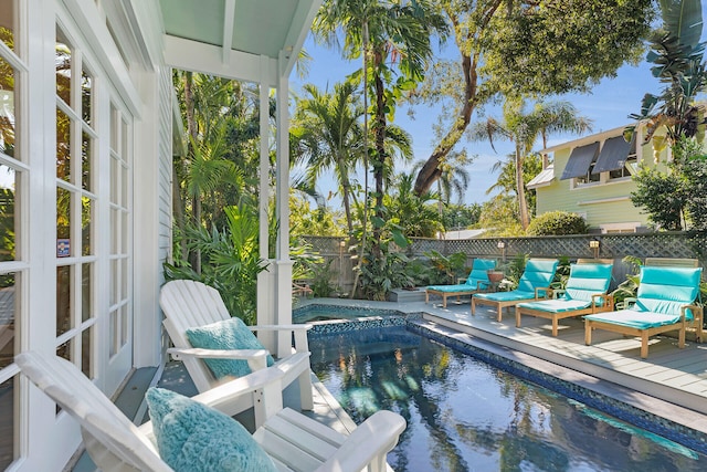 view of swimming pool featuring an in ground hot tub