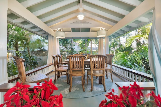 sunroom featuring lofted ceiling with beams