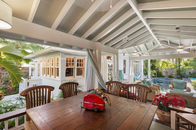 exterior space with vaulted ceiling with beams