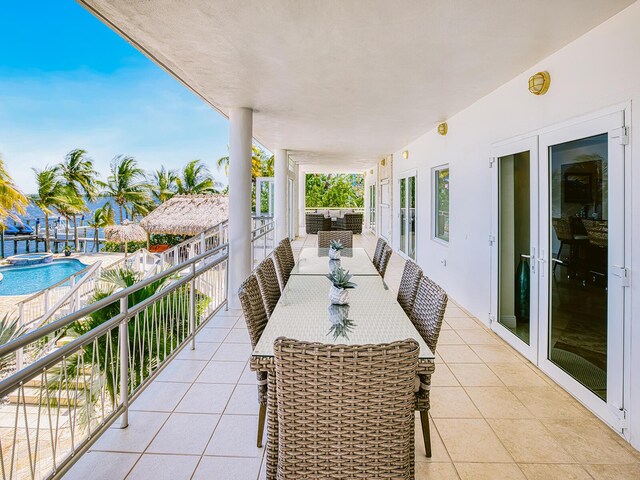 balcony with french doors, outdoor lounge area, and a patio area