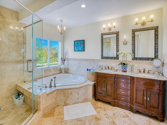 bathroom featuring tile walls, a notable chandelier, vanity, and shower with separate bathtub