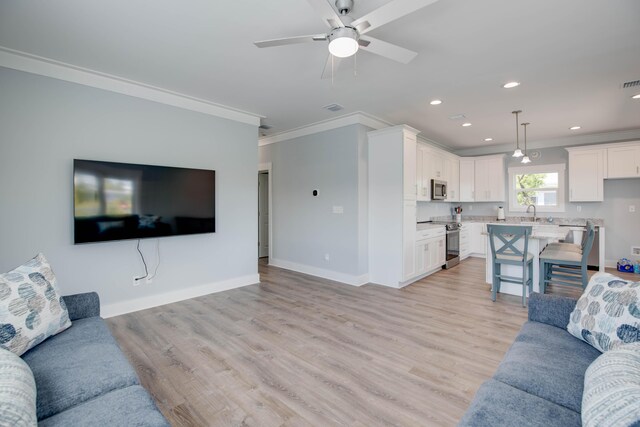 kitchen with white cabinetry, stainless steel appliances, light stone counters, a kitchen bar, and kitchen peninsula