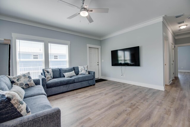 living room with ornamental molding, ceiling fan, and light hardwood / wood-style floors