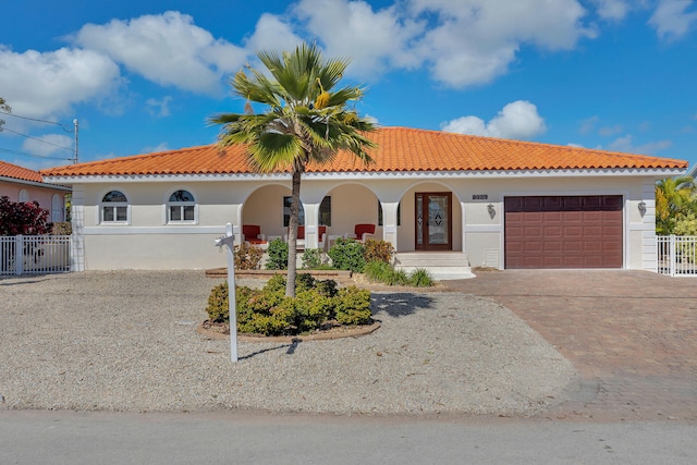 mediterranean / spanish house with a garage