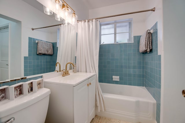 full bathroom with shower / tub combo with curtain, vanity, toilet, and speckled floor