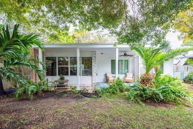 rear view of property with covered porch and ceiling fan