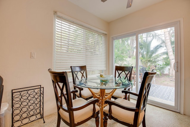 dining space featuring ceiling fan and speckled floor