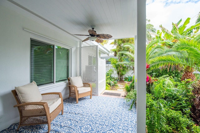 view of patio with fence and a ceiling fan