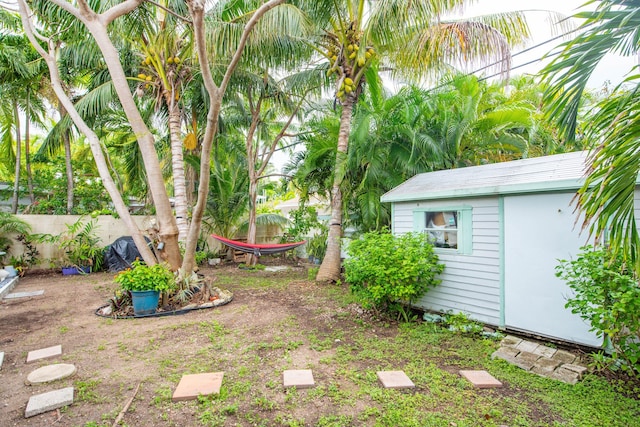 view of yard featuring fence and an outdoor structure