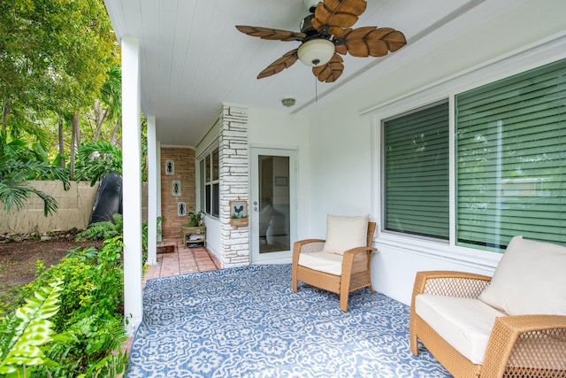 view of patio with fence and a ceiling fan