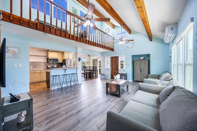 living room featuring a wall mounted AC, high vaulted ceiling, beamed ceiling, ceiling fan, and light hardwood / wood-style floors