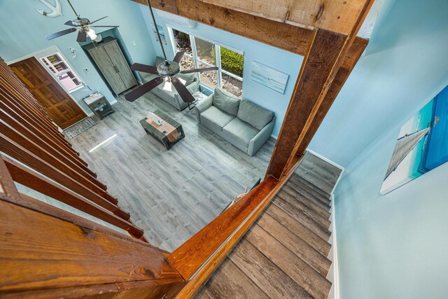 unfurnished living room with hardwood / wood-style floors and ceiling fan