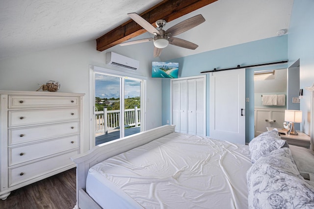 bedroom featuring vaulted ceiling with beams, dark hardwood / wood-style floors, a wall mounted air conditioner, access to outside, and a barn door