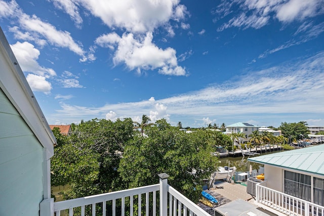 balcony featuring a water view and a boat dock