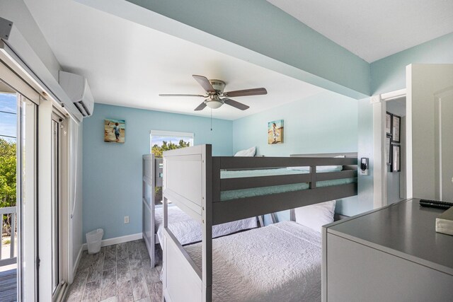 bedroom with ceiling fan, a wall mounted air conditioner, access to exterior, and light hardwood / wood-style floors