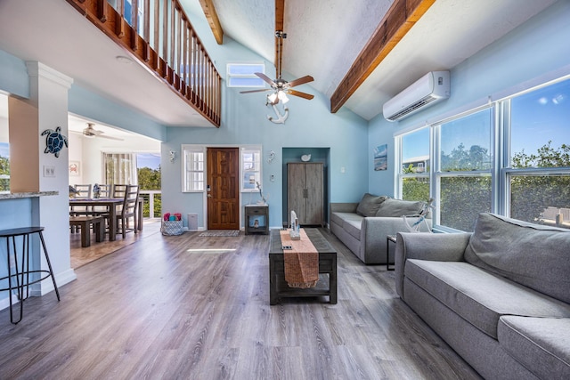 living room featuring high vaulted ceiling, a wall unit AC, hardwood / wood-style flooring, ceiling fan, and beam ceiling