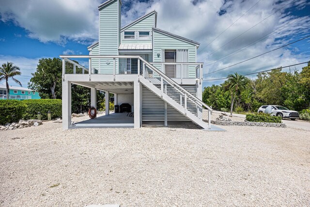 back of property with a carport