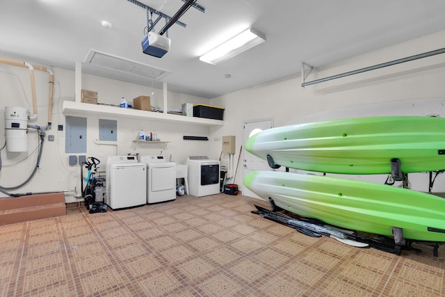 garage with a garage door opener, electric panel, and washing machine and clothes dryer