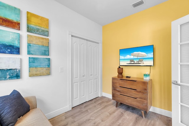 sitting room featuring light hardwood / wood-style flooring