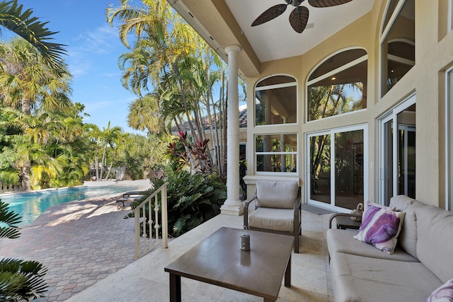 sunroom / solarium with ceiling fan and ornate columns