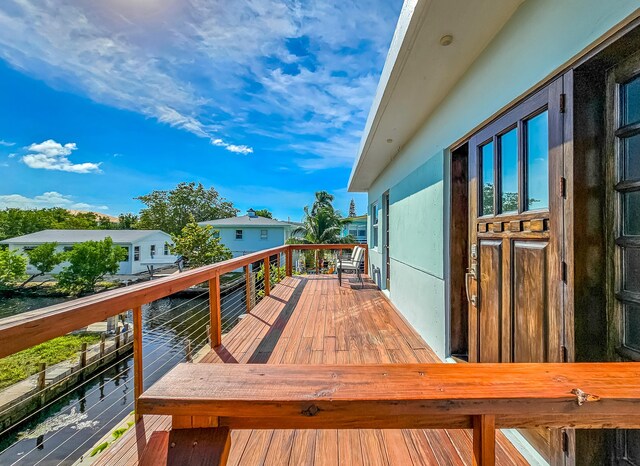 wooden deck featuring a water view