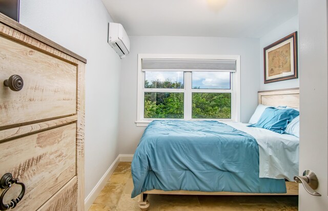 bedroom featuring a wall mounted AC