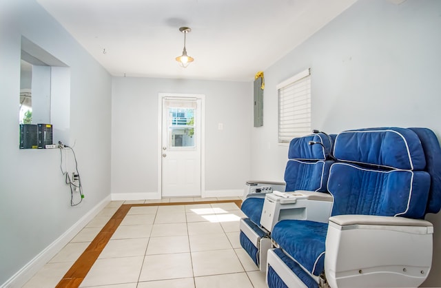 sitting room featuring electric panel and light tile patterned floors