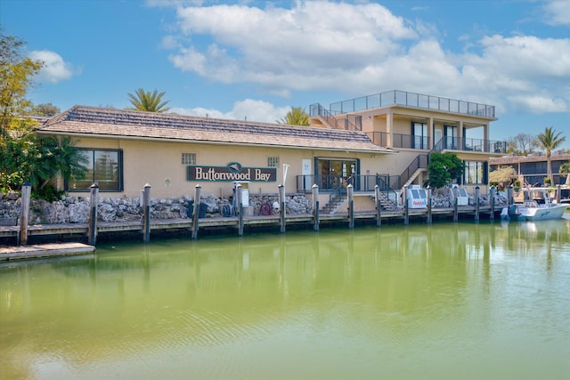 96000 Overseas Hwy Unit X2336Ftslip, Key Largo, FL 33037 - back of property featuring stairs, a water view, stucco siding, and a balcony