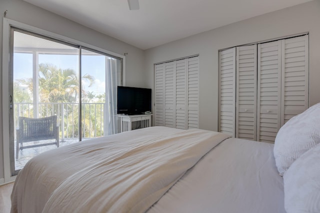 bedroom with multiple windows, two closets, access to exterior, and ceiling fan