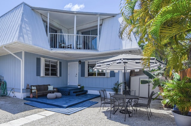 rear view of property with a patio area and a balcony