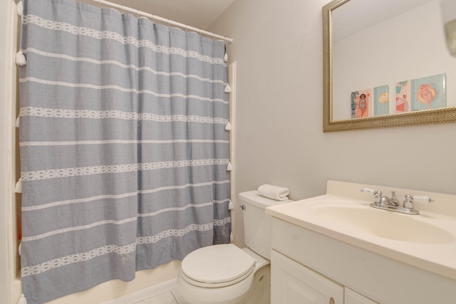 bathroom featuring tile patterned floors, vanity, toilet, and curtained shower