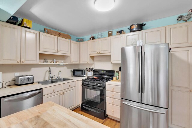 kitchen featuring sink, light hardwood / wood-style flooring, and stainless steel appliances