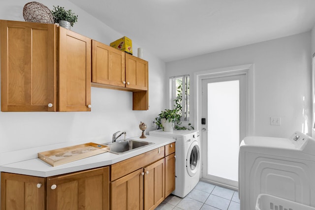 washroom featuring light tile patterned flooring, cabinets, sink, and washer and dryer