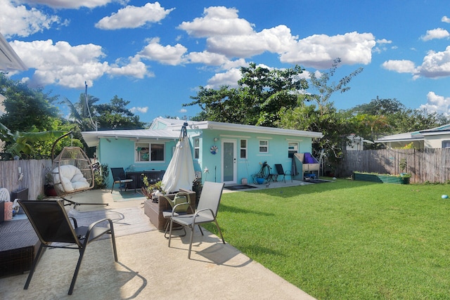 back of house featuring a yard and a patio